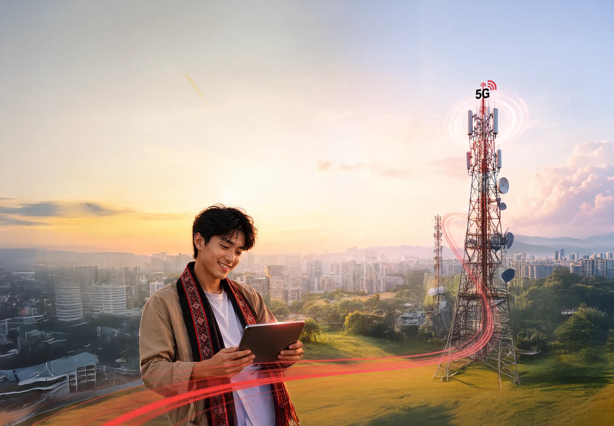 Young man using tablet with city skyline at sunset